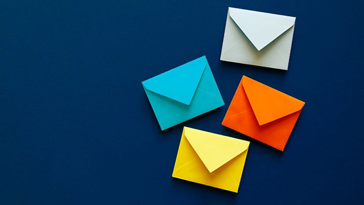 Four colored envelopes sitting on a dark blue background